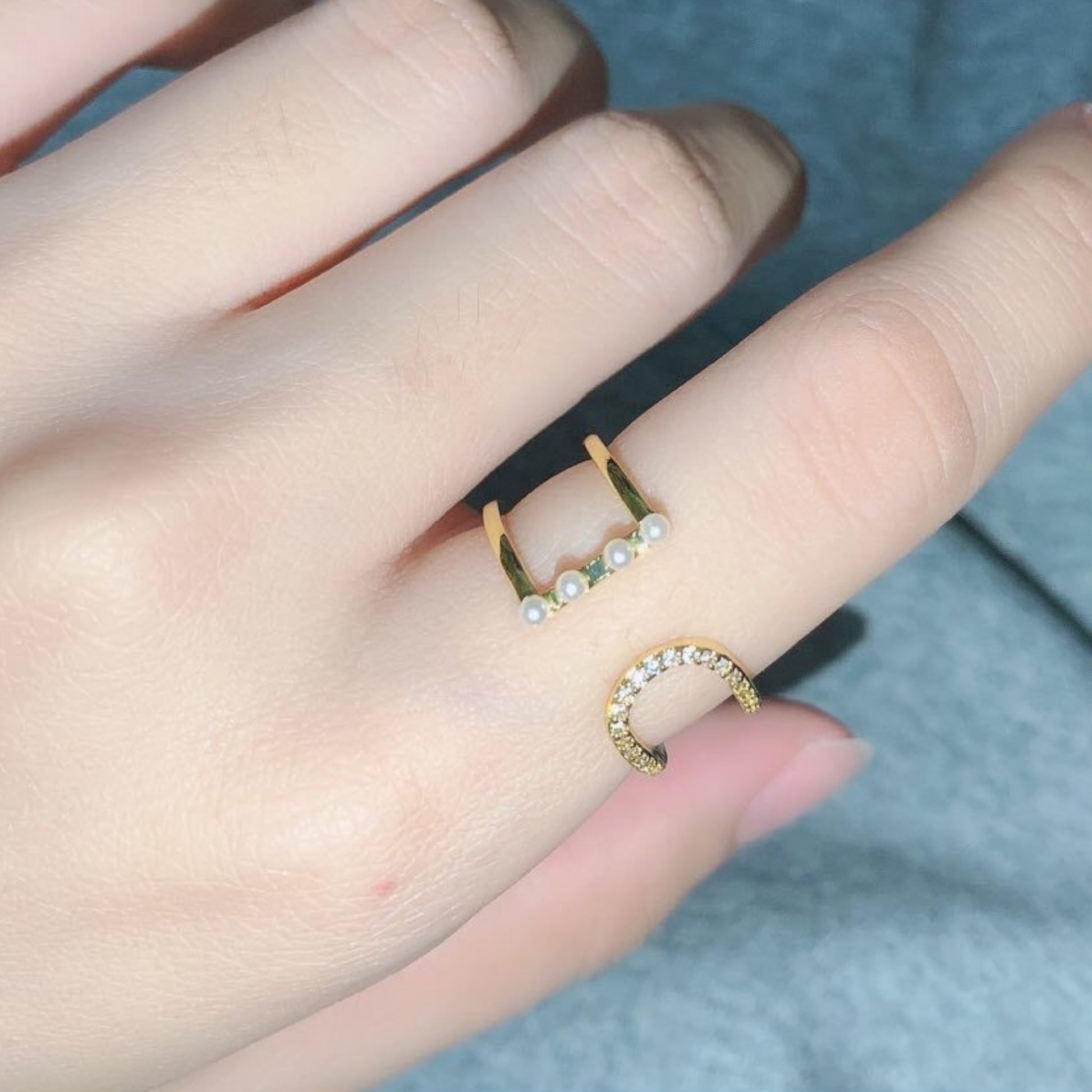 Model wearing the pearl ring, paired with matching gold jewelry for an elegant ensemble.