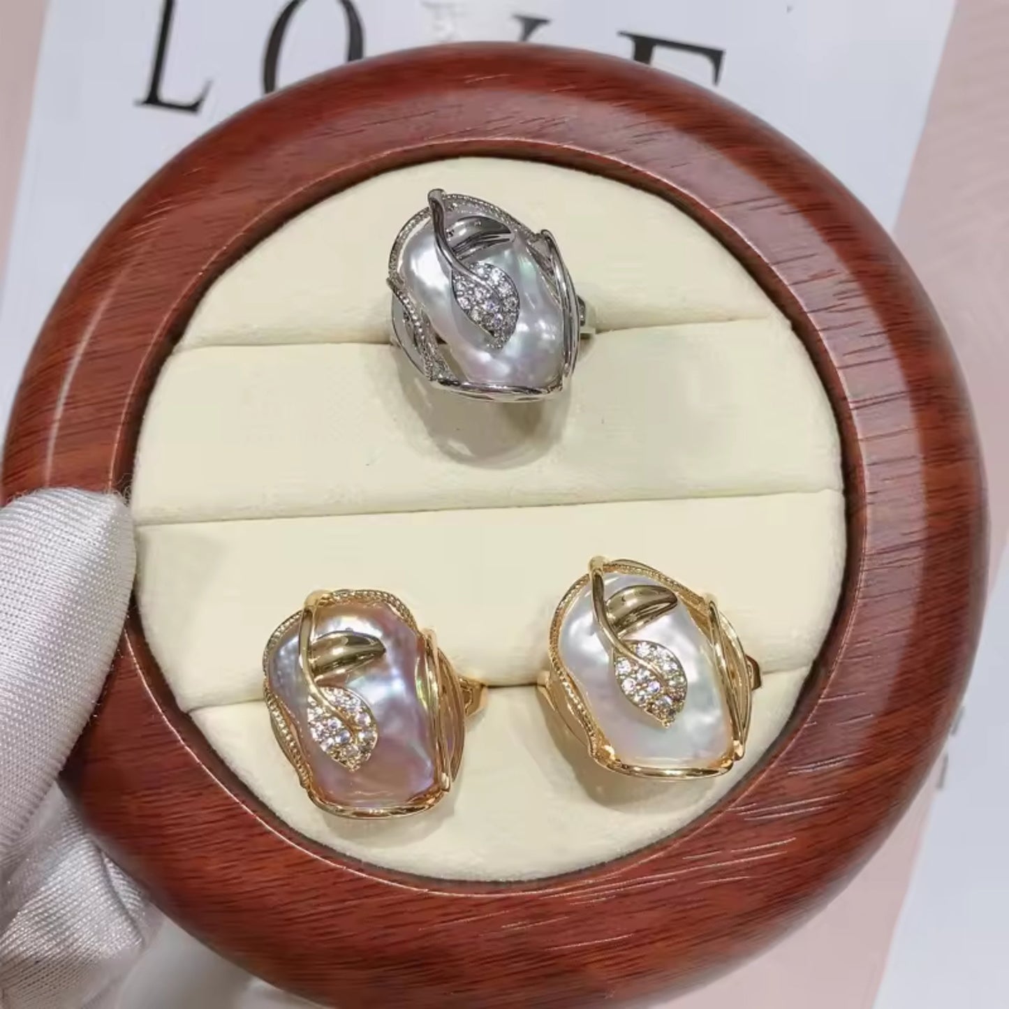 Elegant Pearl Blossom Adjustable Ring with a white freshwater pearl and rhinestone leaf motifs on an 18K gold-plated band.