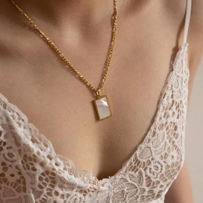 Model showcasing a timeless white shell stone pendant necklace, 18K gold-plated with a sleek stainless steel chain, perfect for casual or formal looks.