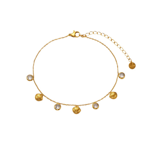 Close-up of an 18K gold-plated seashell anklet with radiant white zircon stones, featuring delicate charms on an adjustable chain against a white background.