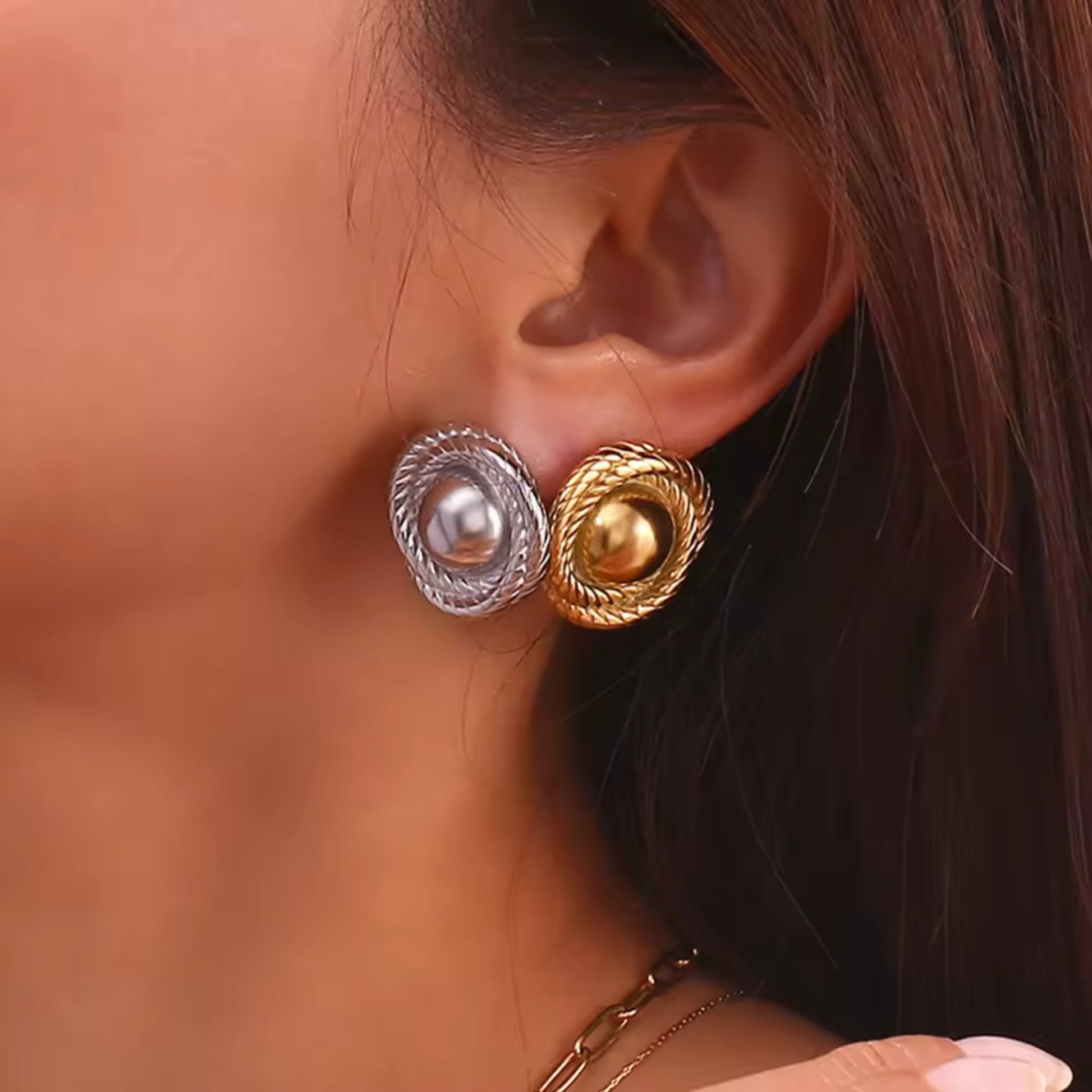 Model showcasing gold and silver-plated twist hoop earrings, styled with a chic evening outfit for a luxurious look.