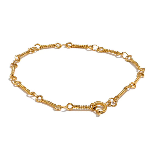 Gold-plated twisted link chain bracelet on a white background, showcasing its intricate design and lightweight elegance.