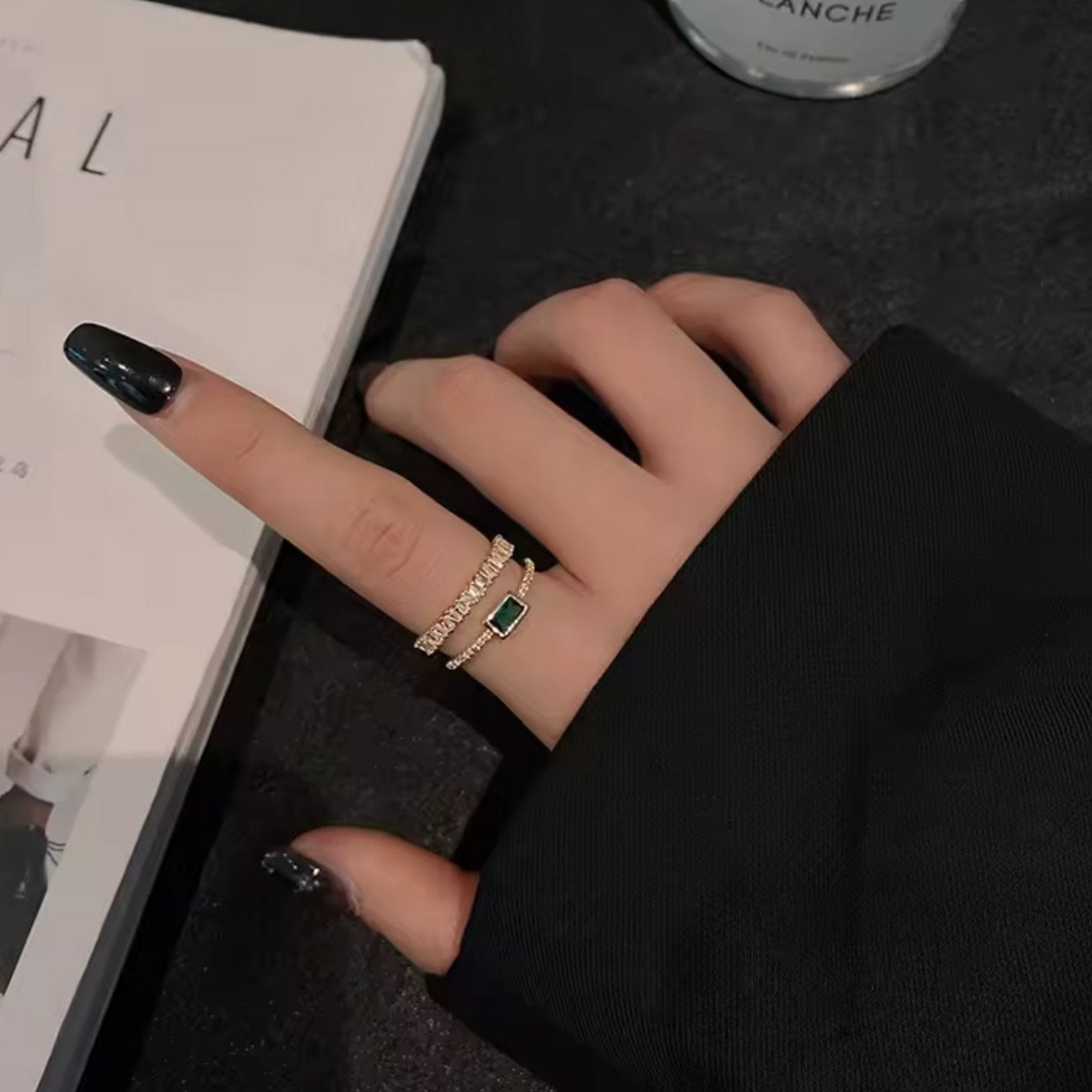 Model showcasing the Emerald Radiance Adjustable Ring, emphasizing its bold green stone and elegant gold design.
