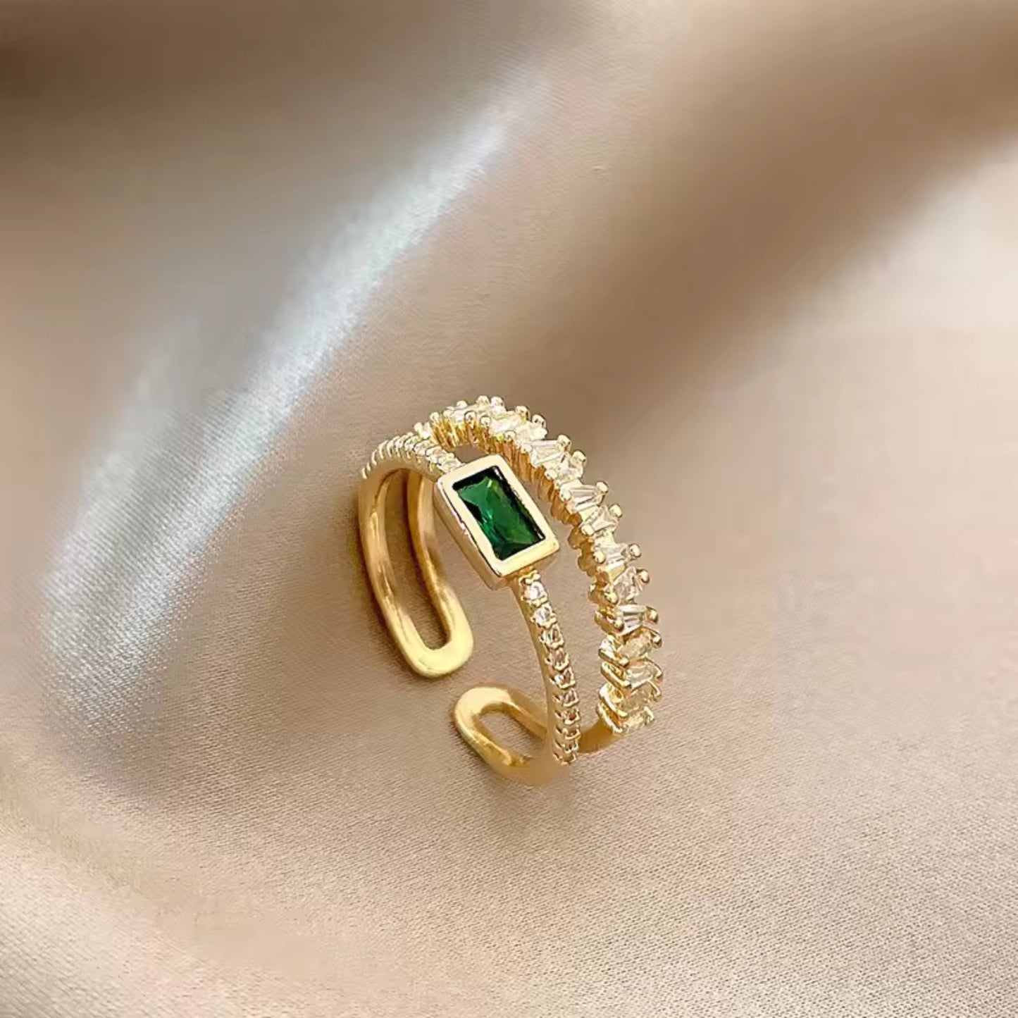 Side view of the Emerald Radiance Adjustable Ring, highlighting the green rectangular zircon and gold-plated band with crystal accents.