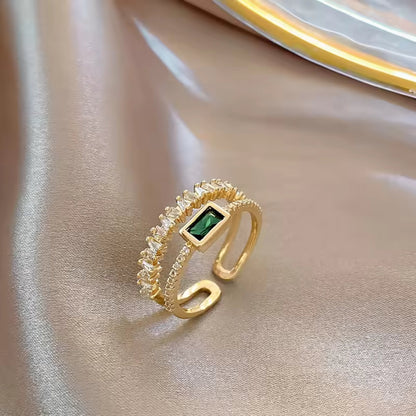 Side view of the Emerald Radiance Adjustable Ring, highlighting the green rectangular zircon and gold-plated band with crystal accents.