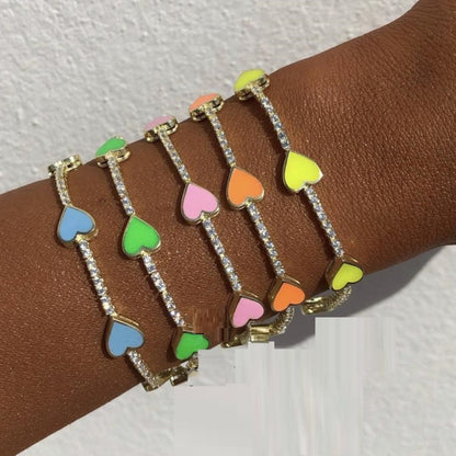 Detailed view of the Enamel Heart Gold Plated Bracelet, showcasing vibrant enamel hearts and sparkling cubic zirconia accents.