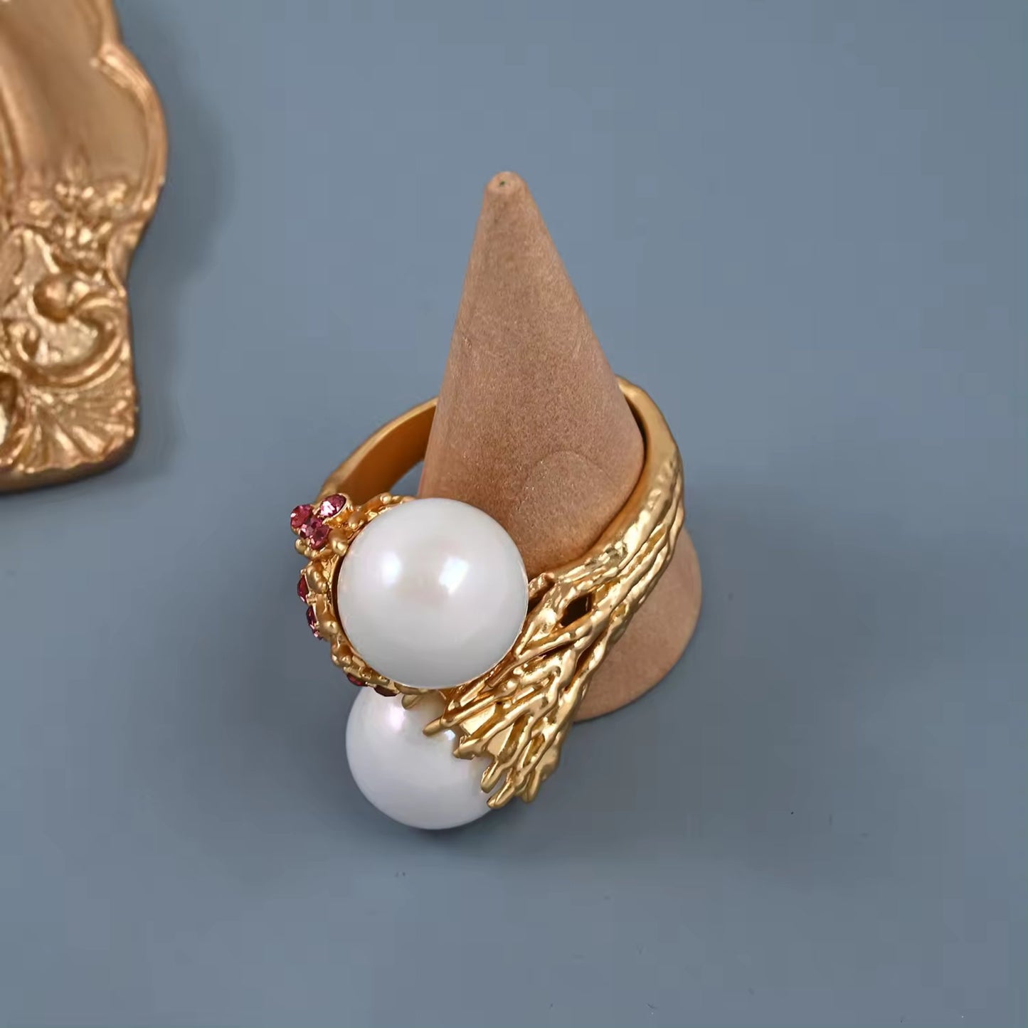 Detailed view of the Enchanted Pearl Branch Ring's luminous pearls nestled in a gold-plated branch design with gemstone accents.