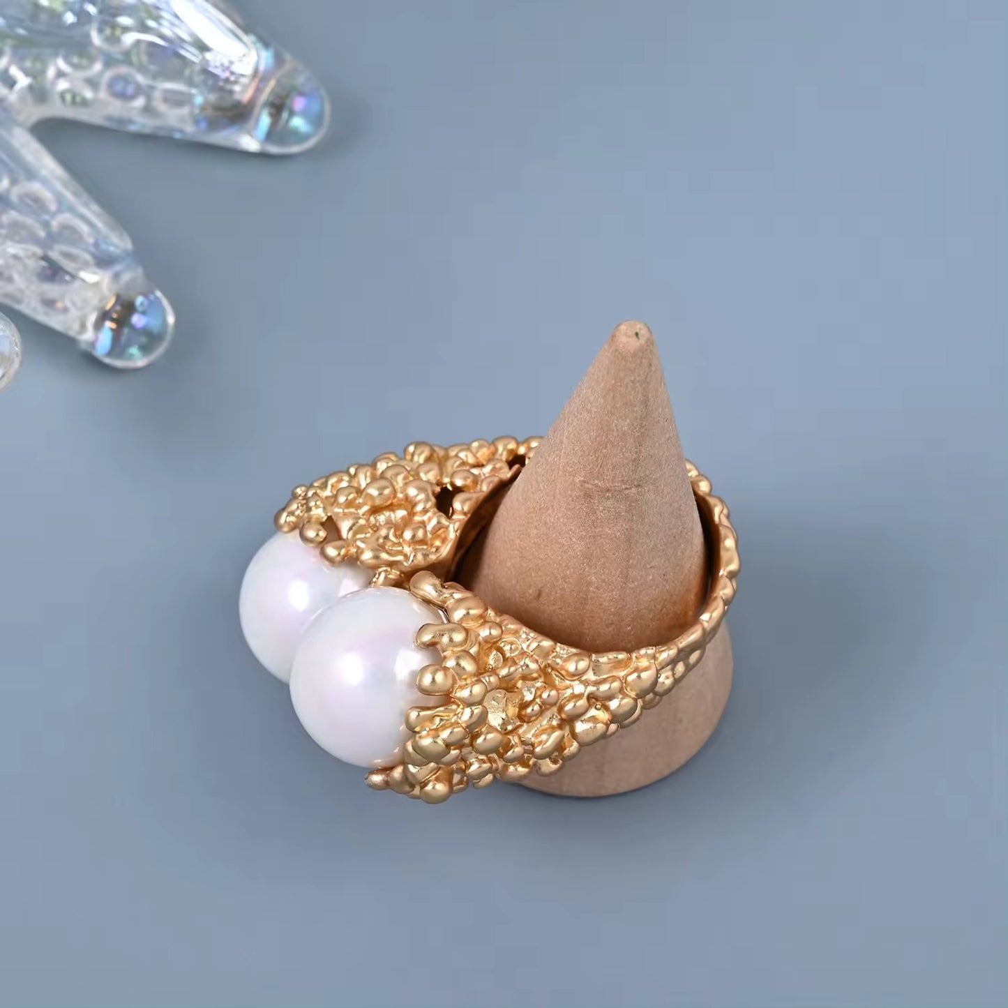 Detailed view of the Enchanted Pearl Branch Ring's luminous pearls nestled in a gold-plated branch design with gemstone accents.
