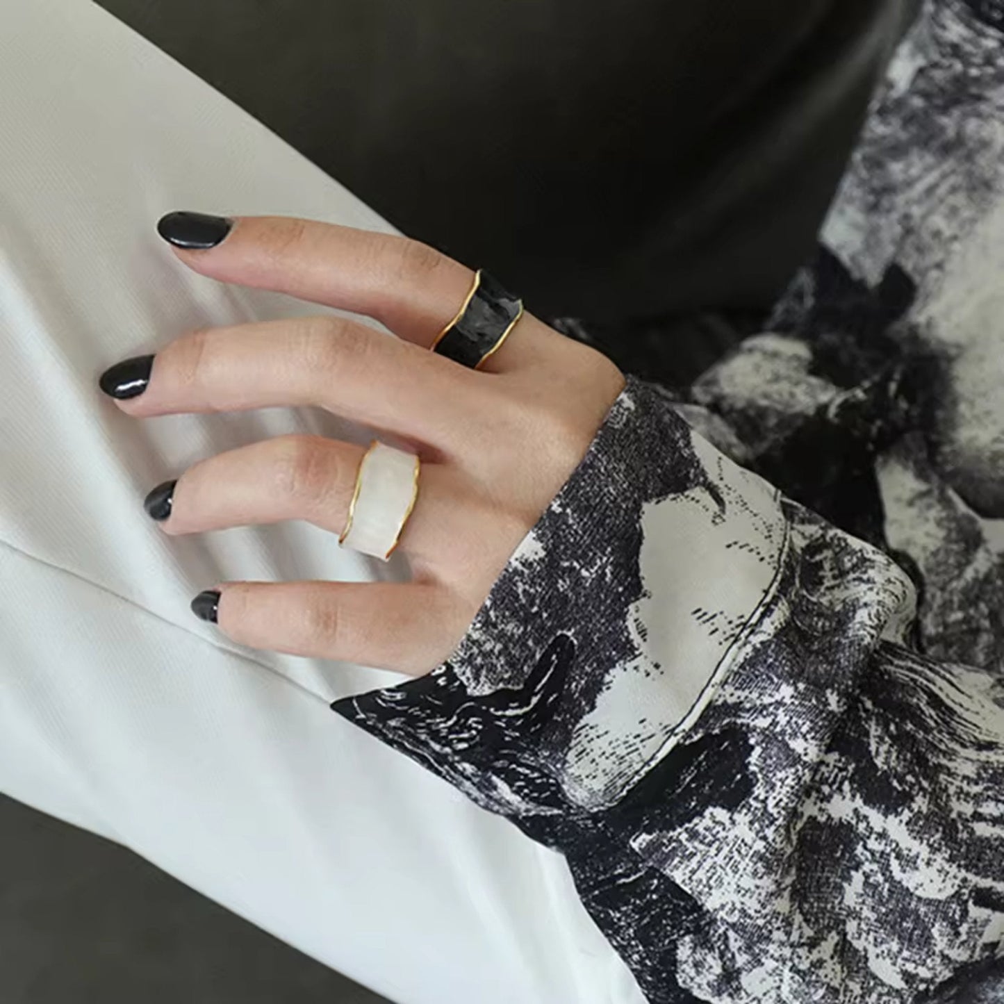 Model styling the Enchanted Wave Rings, displaying the adjustable fit and vibrant enamel colors paired with elegant attire.