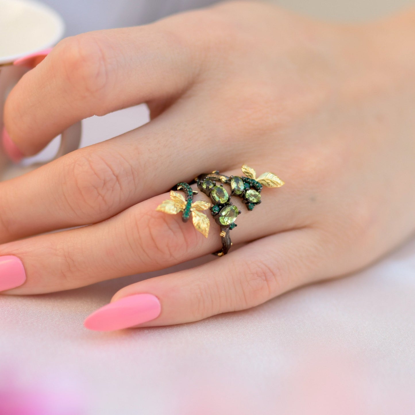 Model wearing the Enchanting Leaves Ring with vibrant green Chrome Diopside stones, showcasing its elegant design and adjustable fit.