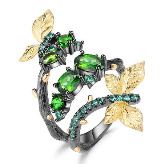 Close-up of the Enchanting Leaves Ring featuring natural Chrome Diopside stones, golden leaf accents, and black gun plating, crafted from 925 sterling silver.