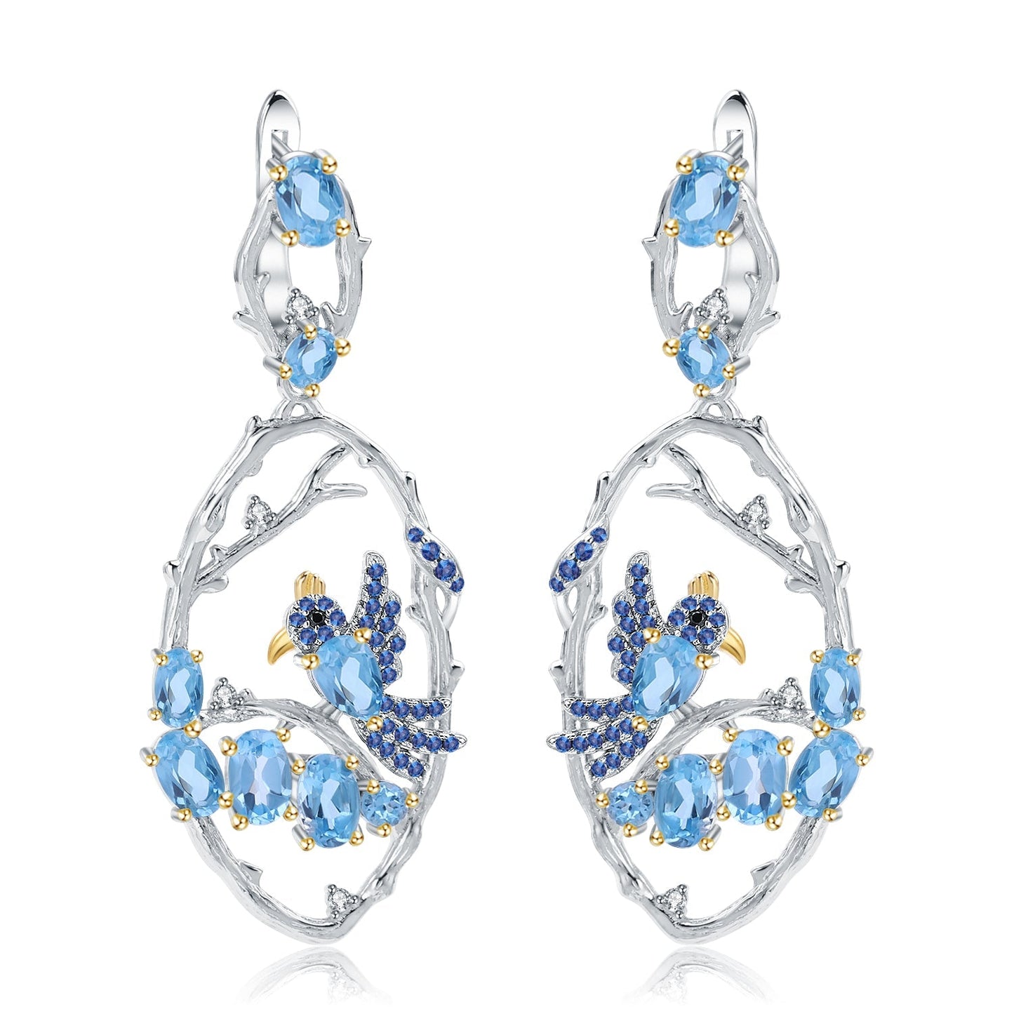 Flat lay of the Ethereal Swiss Blue Topaz Branch Earrings on a white background, emphasizing their elegant design and shimmering blue stones.