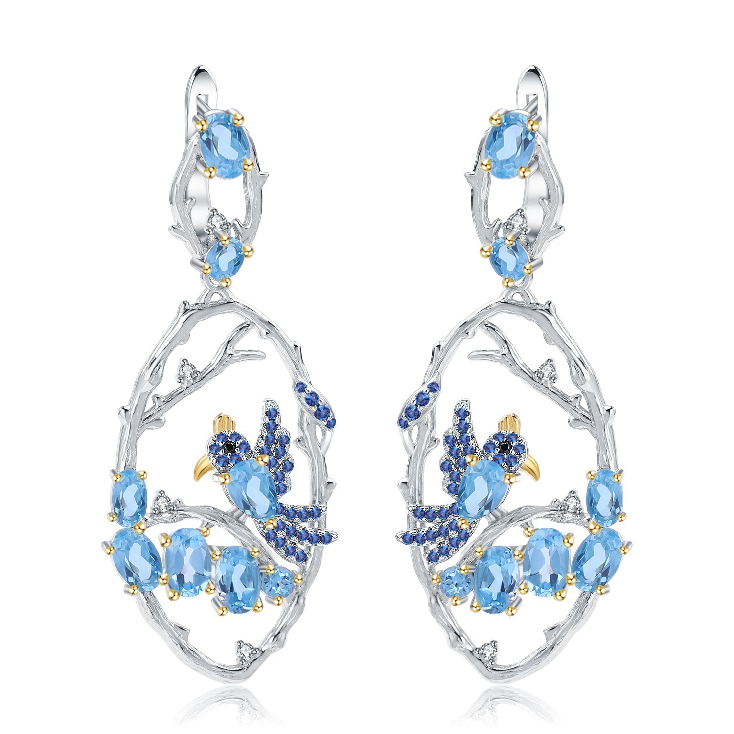 Flat lay of the Ethereal Swiss Blue Topaz Branch Earrings on a white background, emphasizing their elegant design and shimmering blue stones.