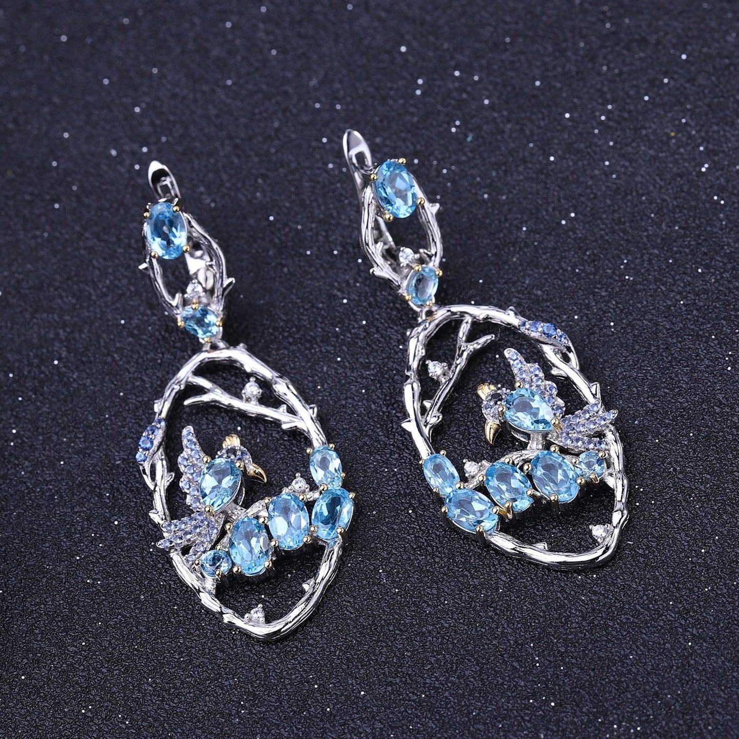 Close-up of Ethereal Swiss Blue Topaz Branch Earrings, featuring natural blue topaz stones set in intricate 925 sterling silver with gold and rhodium plating.