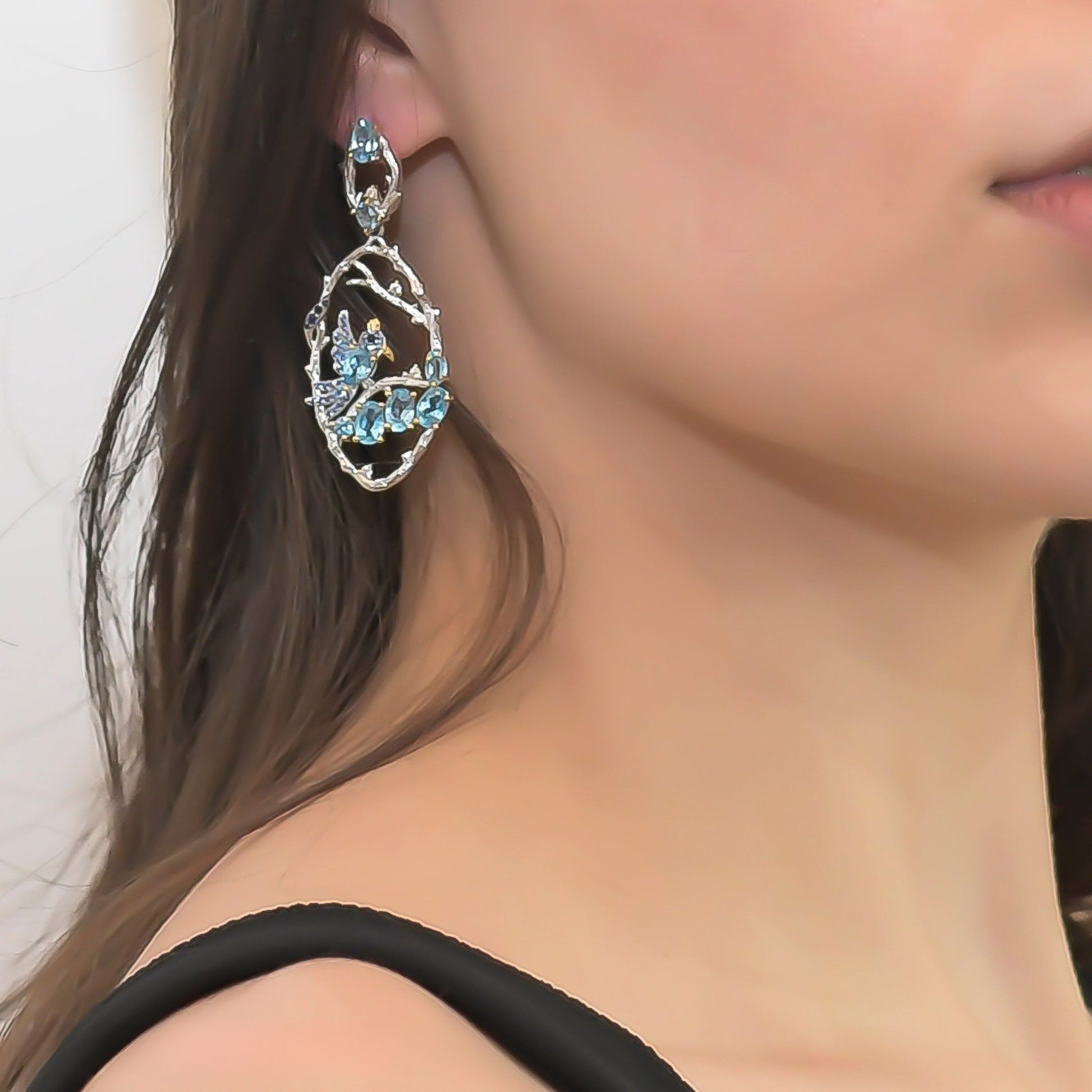 Model showcasing the Ethereal Swiss Blue Topaz Branch Earrings, highlighting their nature-inspired branch design and stunning blue topaz stones.