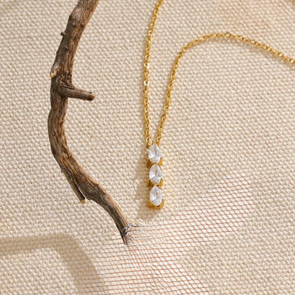 Focused shot of the vertical trio cubic zirconia pendant catching the light, showcasing its brilliant sparkle.