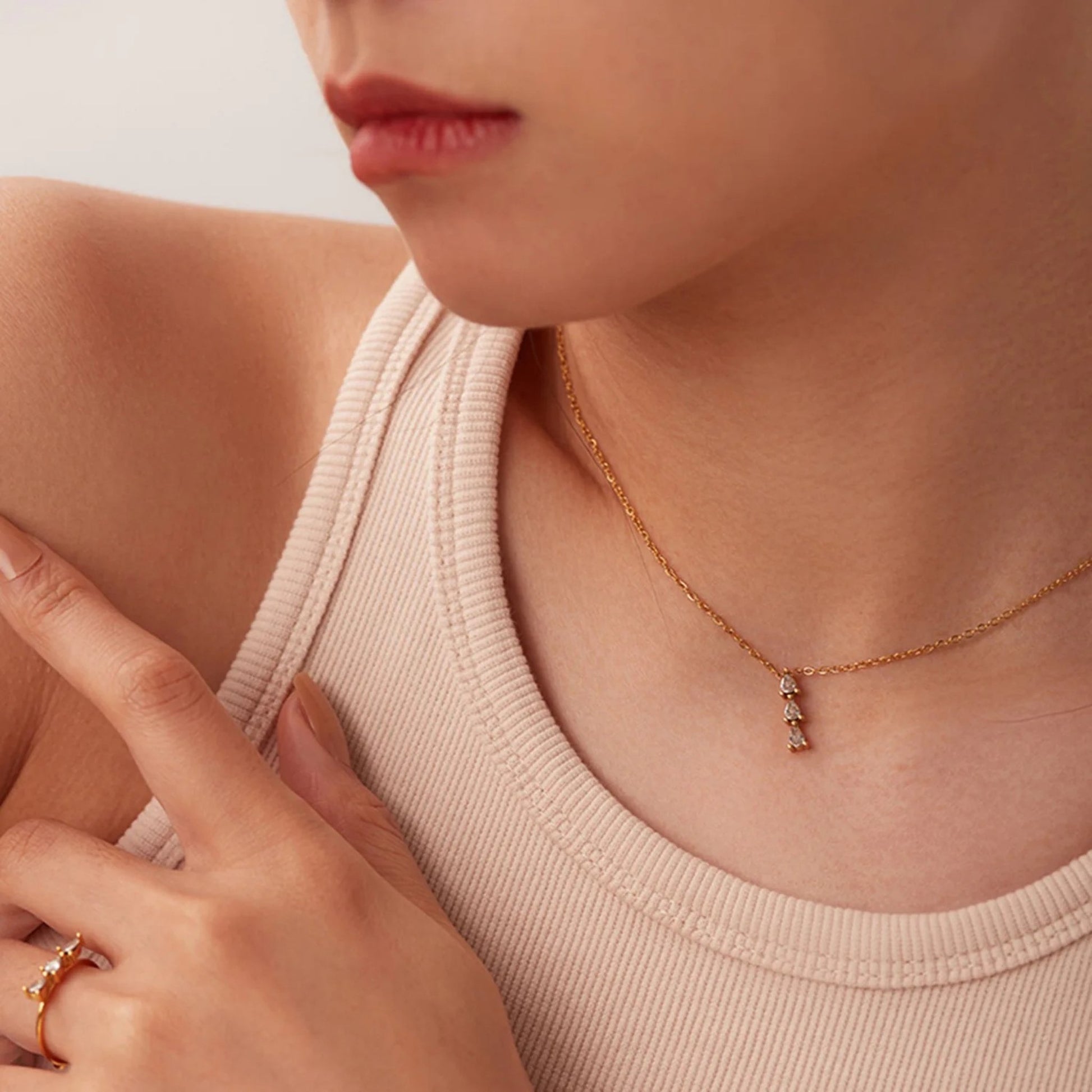 Model wearing the Exquisite Shimmer Pendant Necklace, showing how it complements both casual and formal outfits.