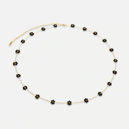 The Midnight Bloom Belly Chain with bold black floral charms, perfect for evening wear and special occasions.