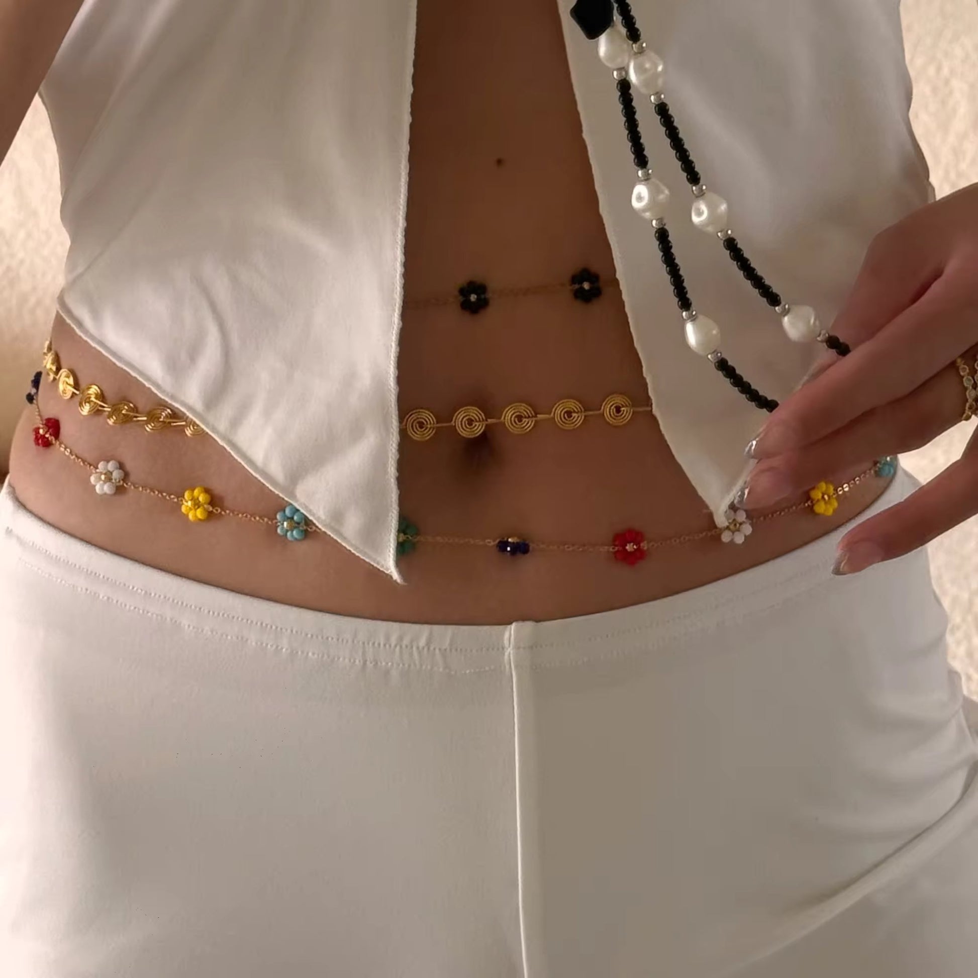 Close-up of the adjustable lobster clasp and extension chain, demonstrating the comfortable, customizable fit of the Floral Harmony Belly Chain Set.