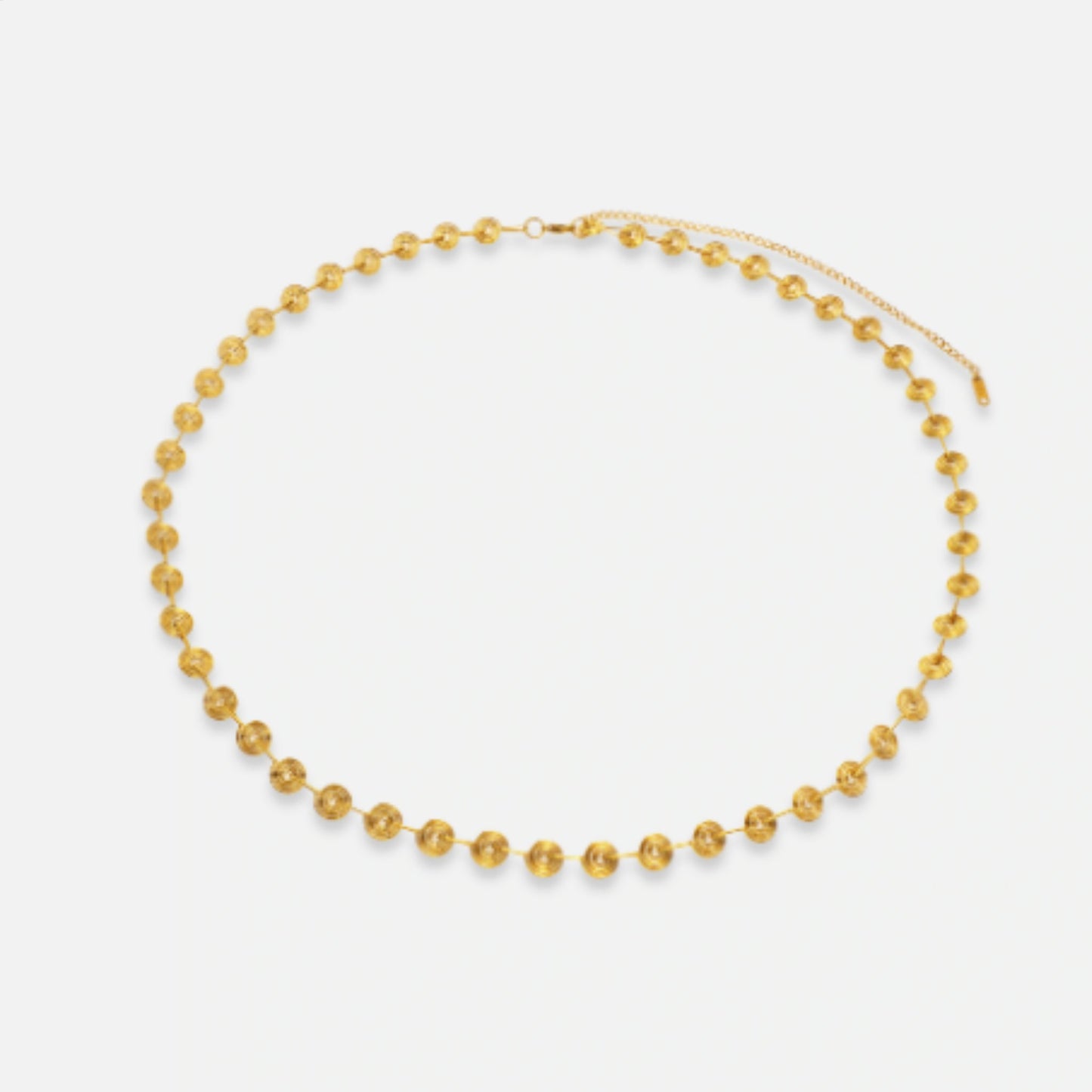 Close-up of the Golden Spiral Belly Chain, featuring sleek gold spiral accents on a stainless steel chain plated with 18K gold.